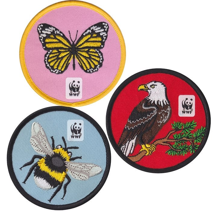 This image shows three embroidered wildlife patches featuring a yellow butterfly, a bald eagle, and a black-and-yellow bee, each with the WWF logo.