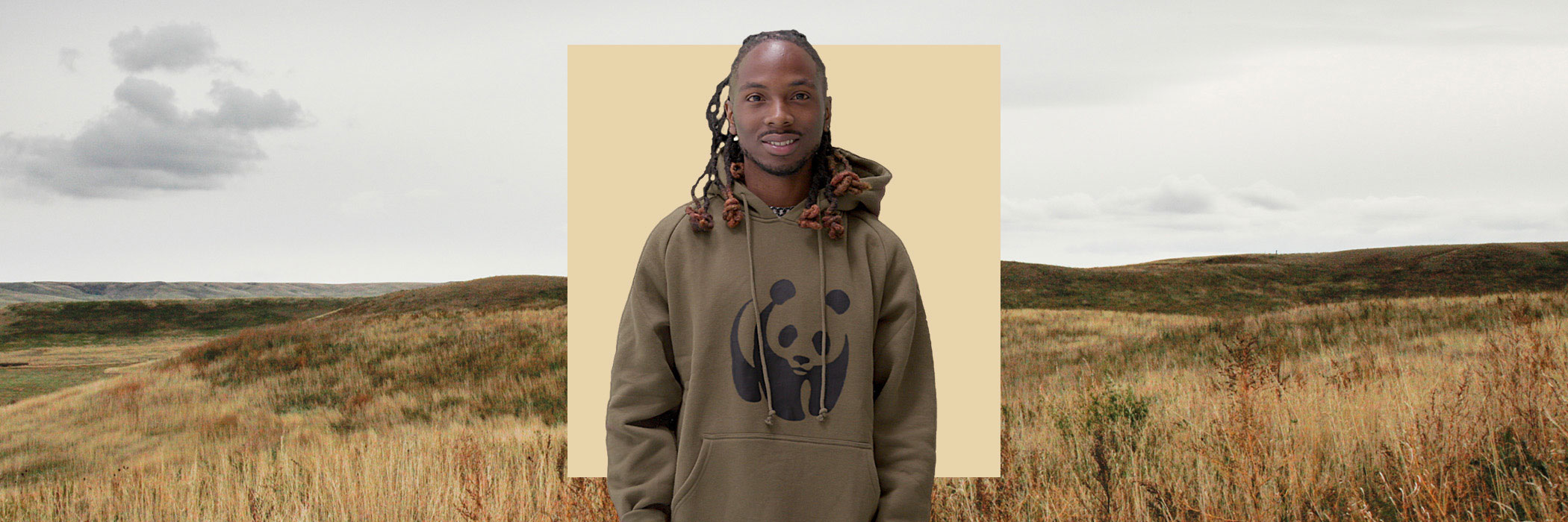man in green Panda Hoodie in front of yellow square in front of plains