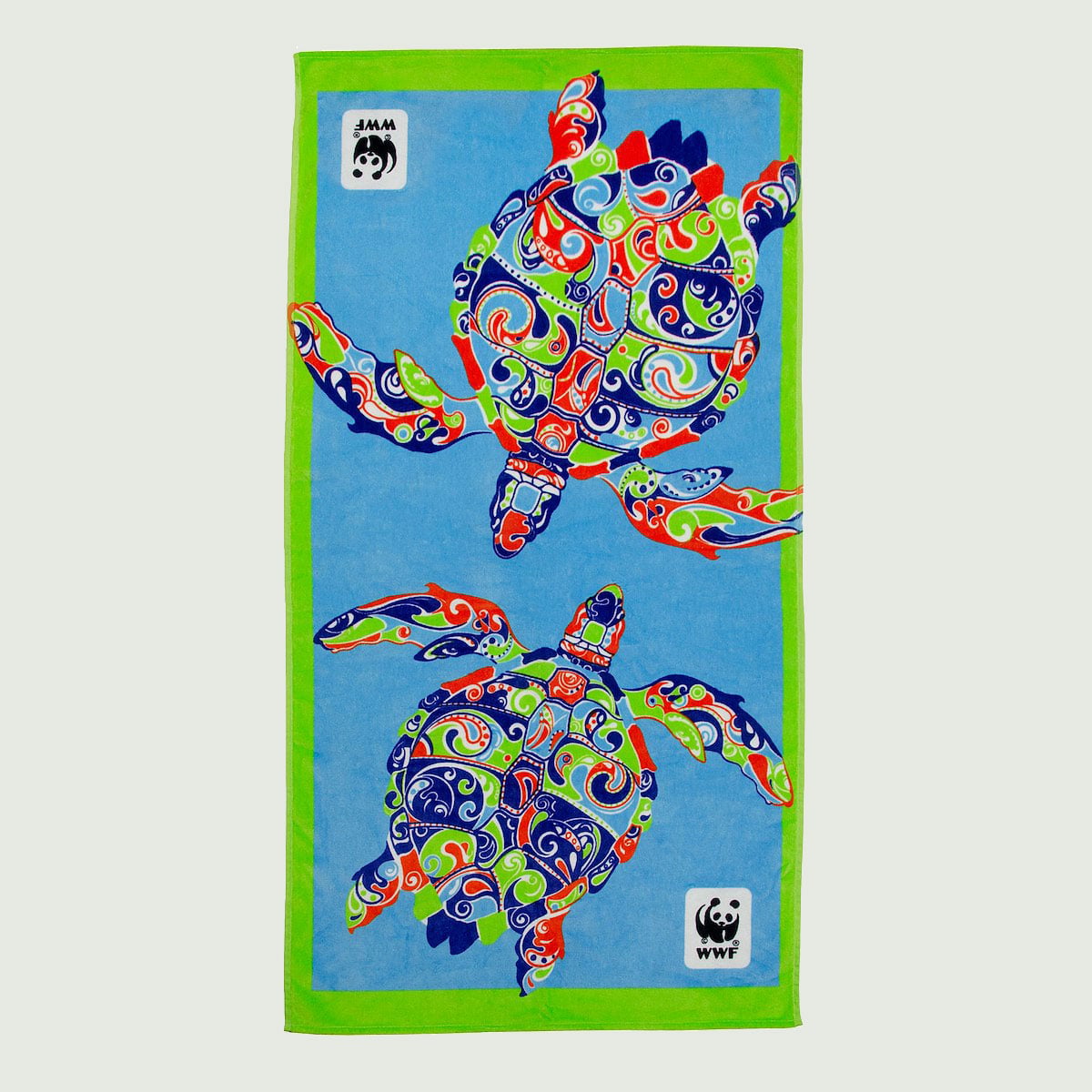 A colorful beach towel featuring two intricately patterned sea turtles with a WWF logo in the corners.
