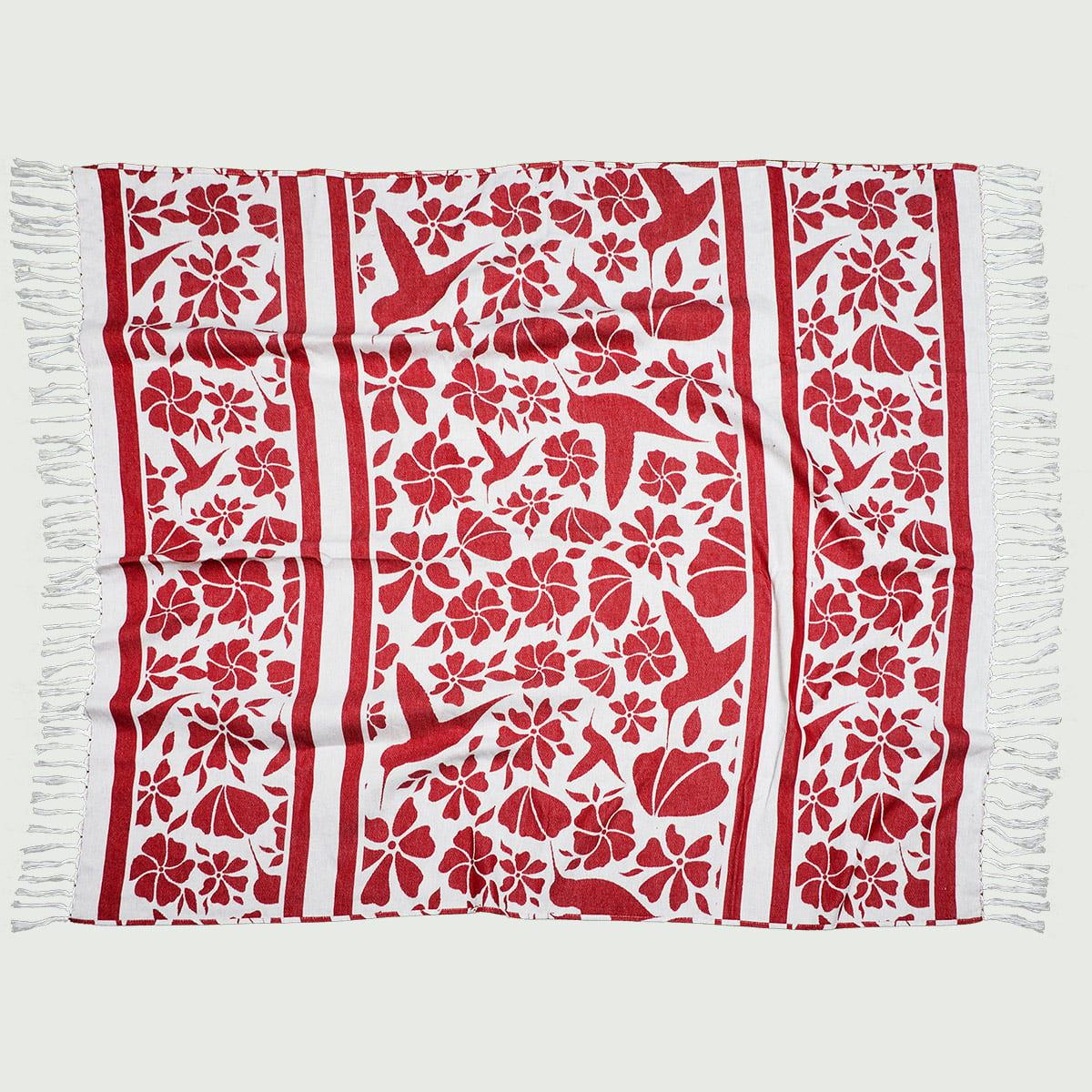 A rectangular red and white patterned textile with floral and bird motifs, bordered by fringe on the shorter edges.