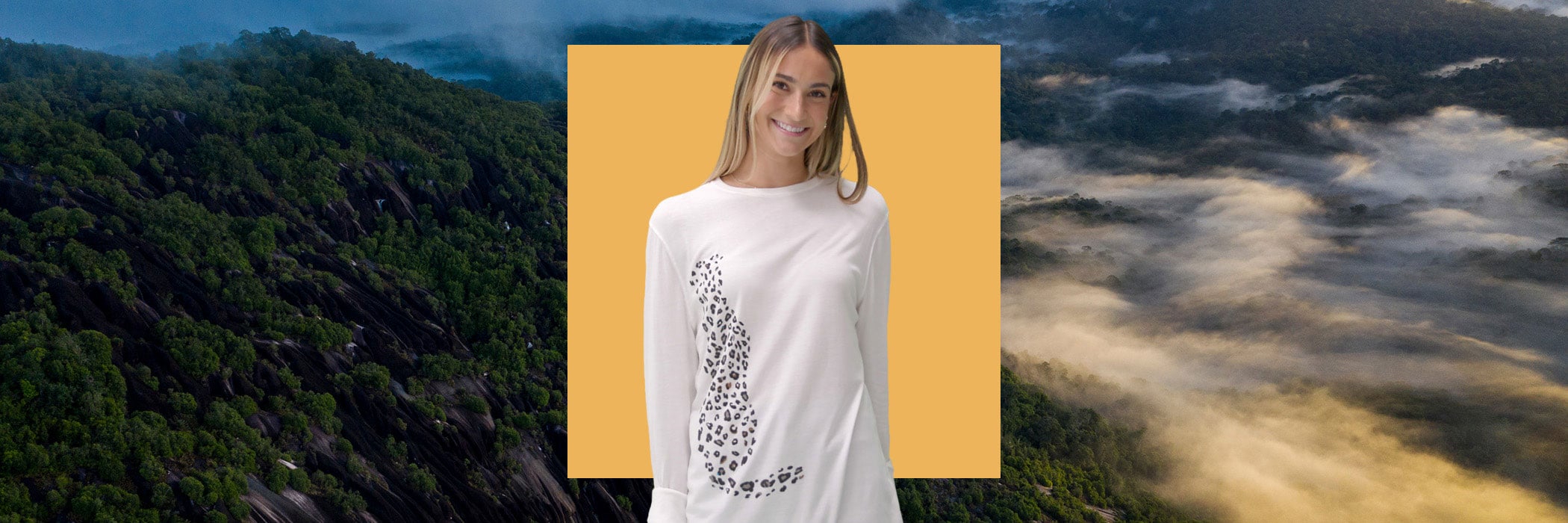 Woman with snow leopard T-shirt on yellow square in front of mountains