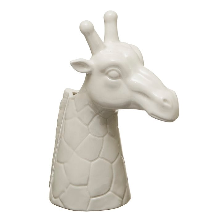 A white ceramic vased shaped like a giraffe head. Flowers could be put in the neck