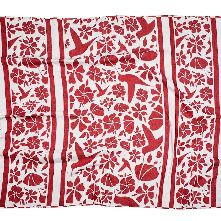 A red and white towel with hummingbirds and flowers