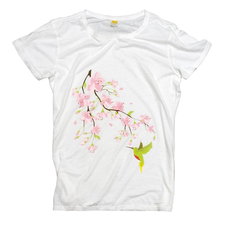 A white t-shirt with green humminbird and pink flowers