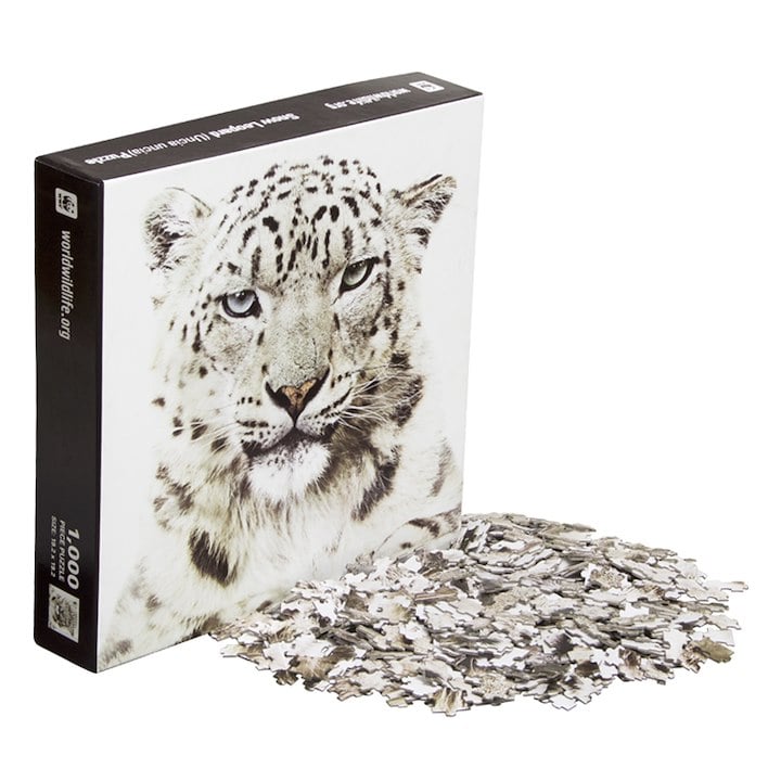A snow leopard puzzle box cover with a pile of pieces