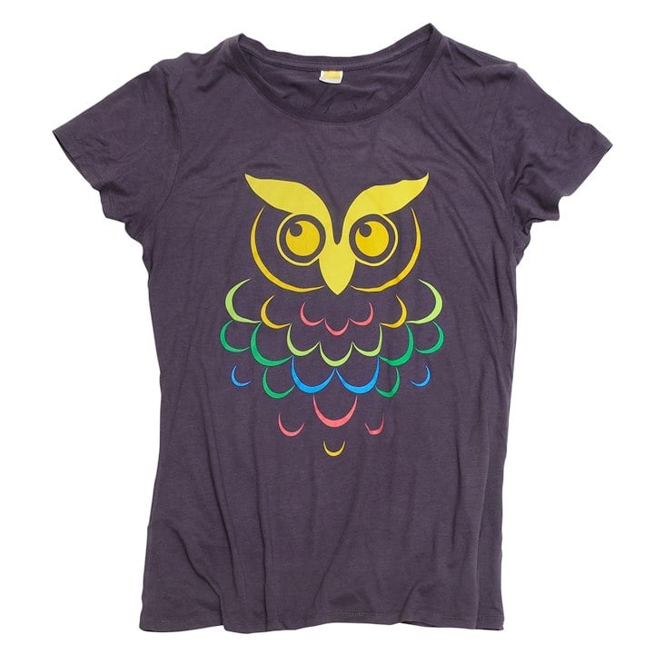 A purple shirt with a colorful owl on it looking up