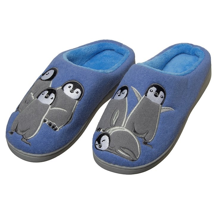 A pair of blue slippers featuring cute penguin designs on the upper surface.