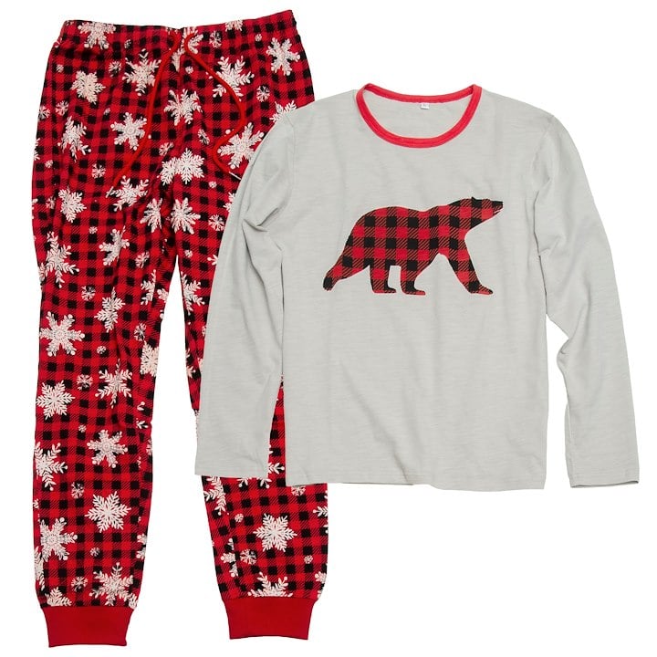 White pajama top with checkered red and black bear silhouette and plaid red, black, and white bottoms with snowflakes