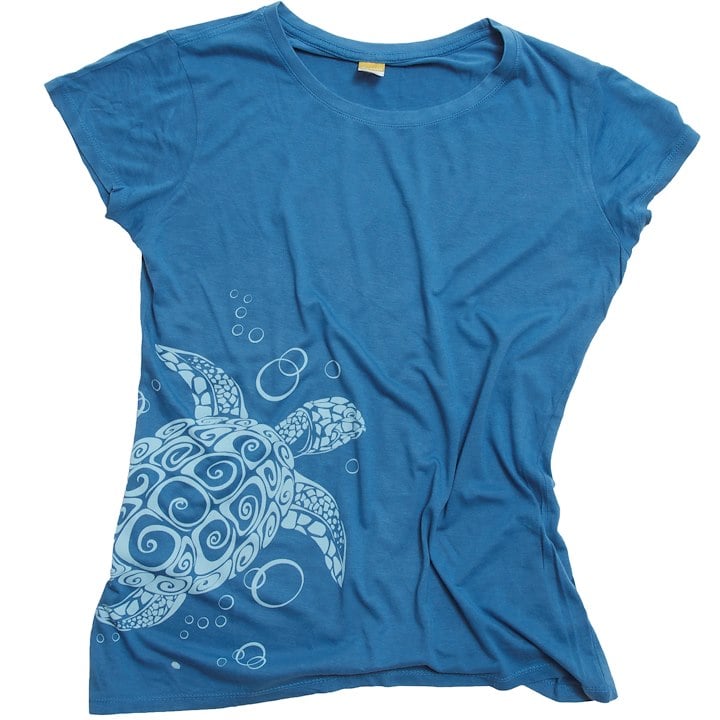 A blue T-shirt features a white, intricate sea turtle design with bubble accents.