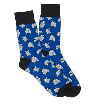 A pair of blue socks with black accents featuring a pattern of cartoon penguins.