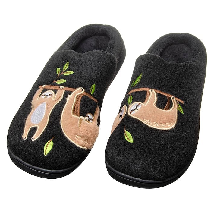 A pair of back slippers with 4 sloths on them hanging from a branch