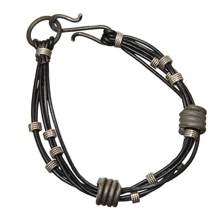 A black and silver bracelet made from snare wire