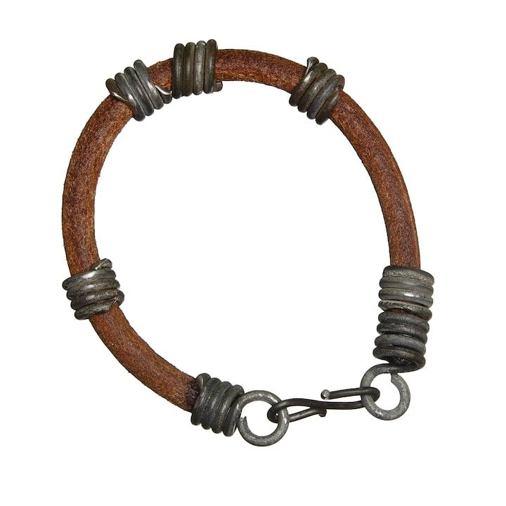 A brown bracelet with repurposed snare wire