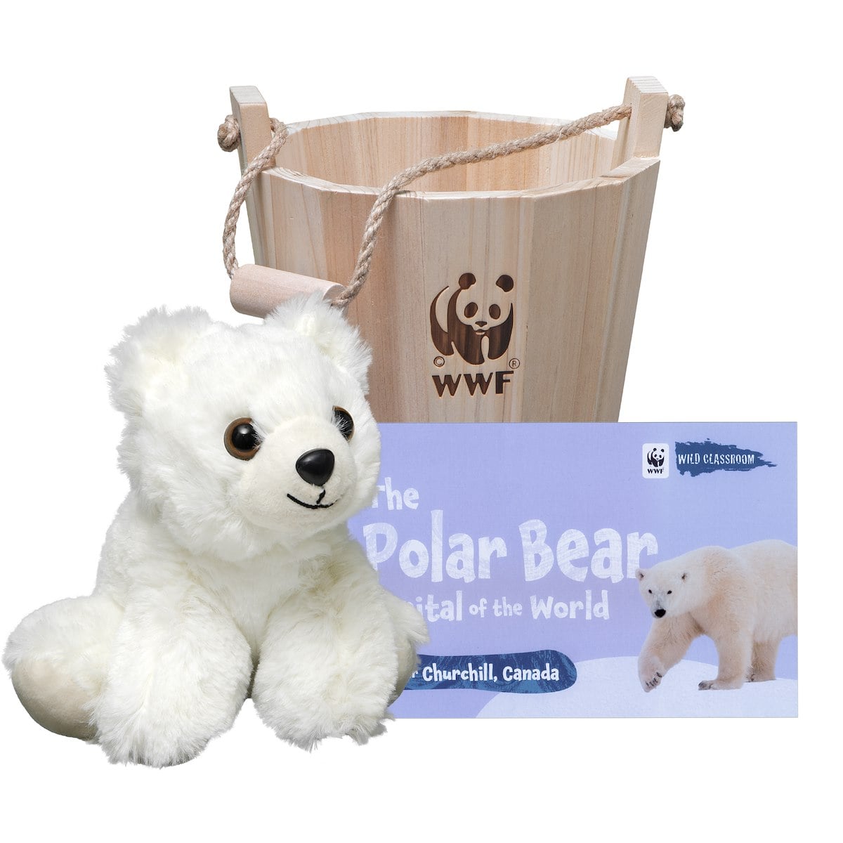 A white stuffed bear next to a bucket and book